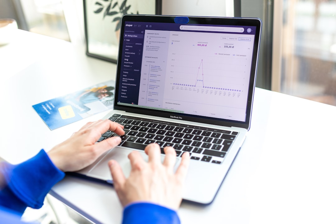 Shopify dashboard displaying clothing store products and analytics on laptop screen